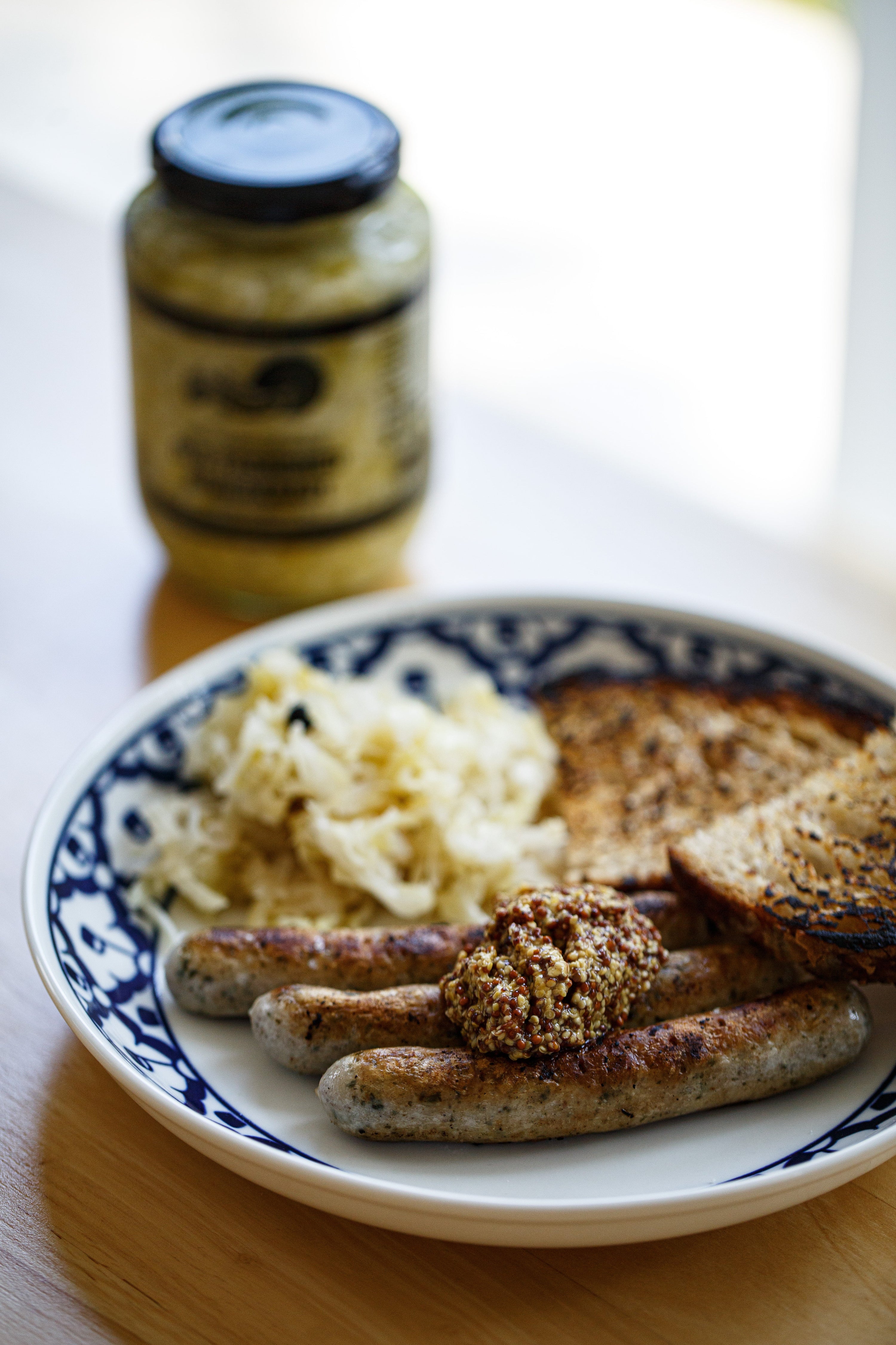 Choucroute and sausage dish with sauerkraut jar